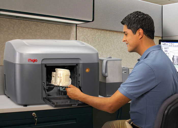 Stratasys Mojo 3D Printer in use by an engineer.