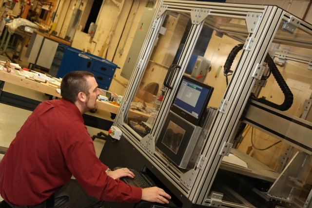 Materials engineer at work on Picatinny Arsenal's Multi-Axis Modular Manufacturing Platform. Courtesy of the US Army. 